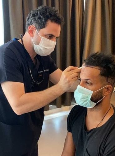 Dr Acar marking Ricky Whittle's new hairline