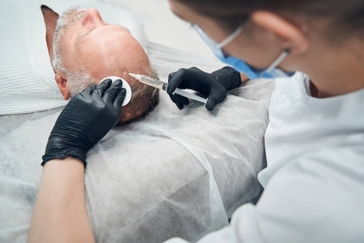 Regenera activa: A man is getting progenitor cells injected into his scalp