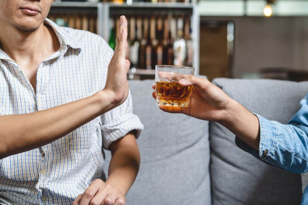 Photo of a man refusing alcohol after a hair transplant