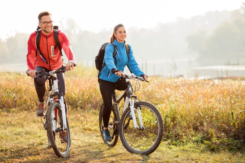 Young couple enjoying early morning bicycle ride