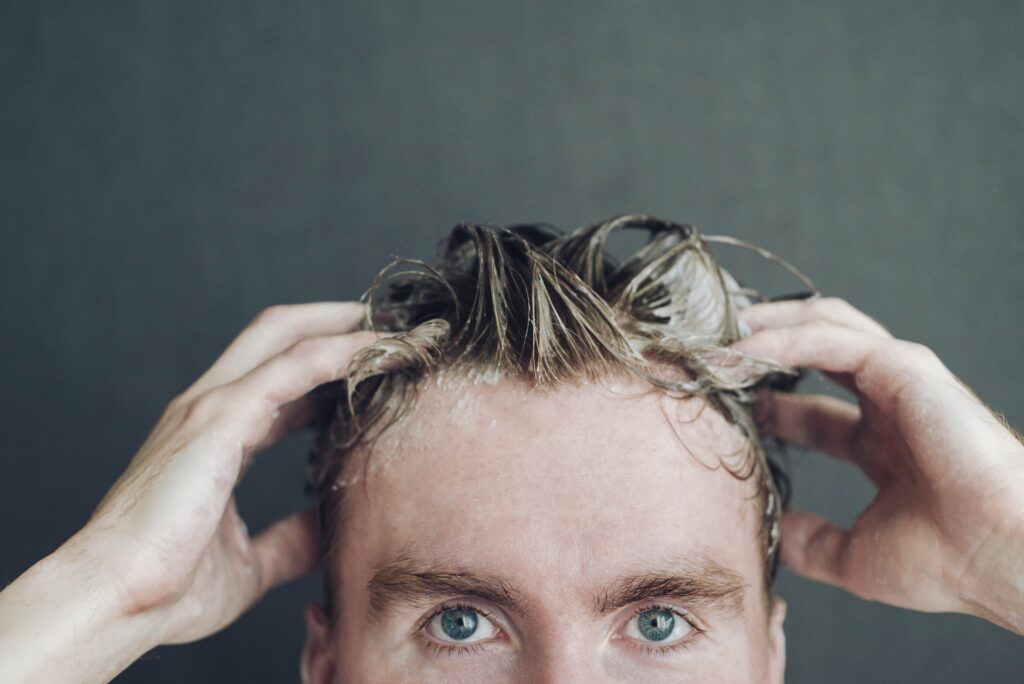 a man washes his hair after a hair transplant