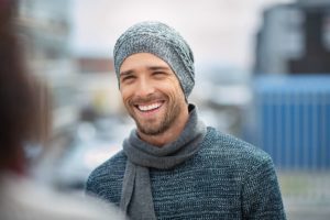 Smiling man with hat and scarf