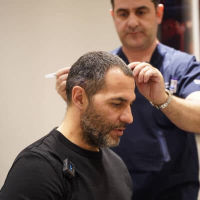 Image of Spanish actor Mario de la Rosa doing a hair transplant consultation with Dr. Levent Acar at Cosmedica Clinic