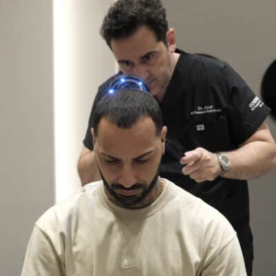 Dr. Levent Acar performs Ricardo Quaresma's hair analysis before his hair transplant