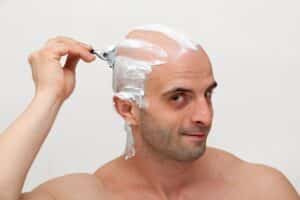 Man sheves his head before a hair transplant