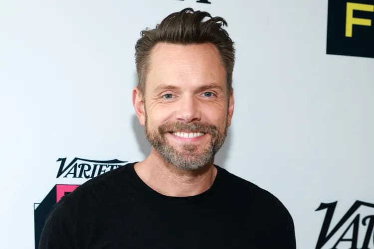 Joel McHale attending a press event with thick, styled hair, post-transplant