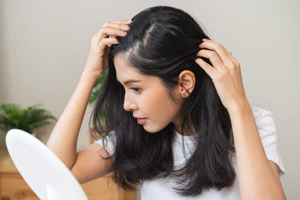 Woman checking scalp before Oxygen Hair Treatment