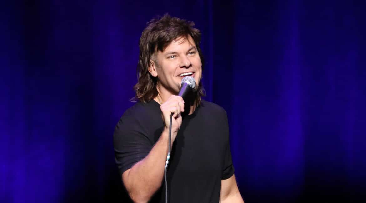 Theo Von doing Standup Comedy with a mic in his hand